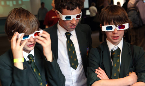 School pupils on campus wearing 3D glasses.