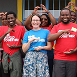 People making a world and heart symbls with their hands