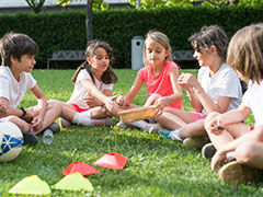 A group of children sat on grass