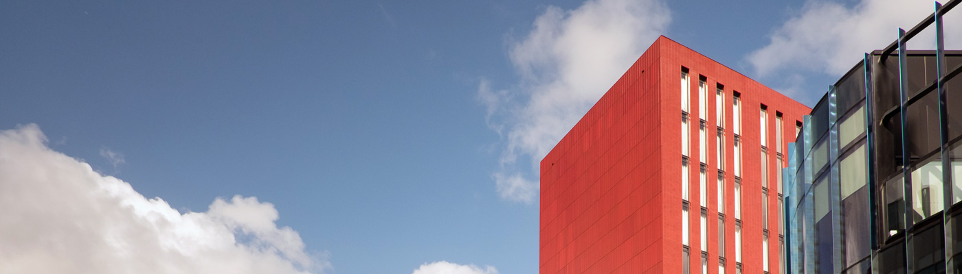 Red building against blue sky, Manchester