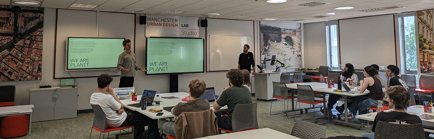 Students watch a We Are Planit presentation in the Manchester Urban Design Lab studio classroom.