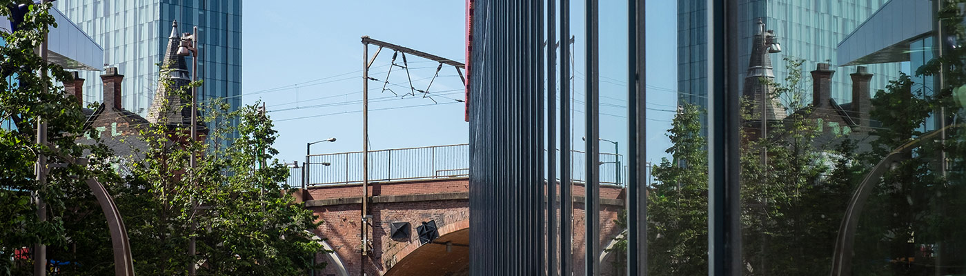 building, tram lines and trees in Manchester