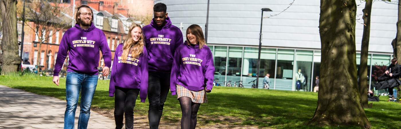 Four students walking past University Place laughing.